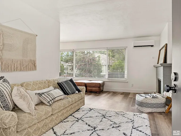 Glenmanor living room before: plain beige sofa and bare white walls