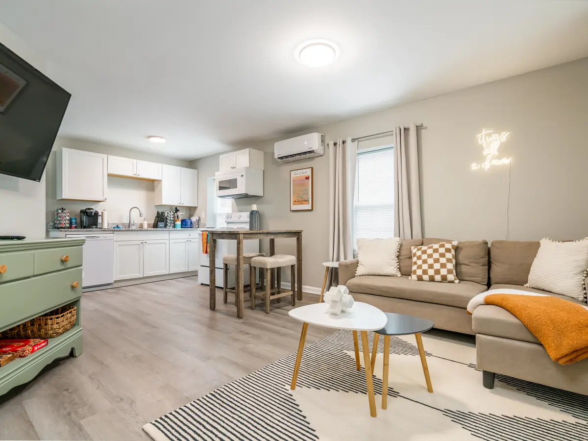 House St living and kitchen guest-ready: sofa, dining nook, stocked kitchen