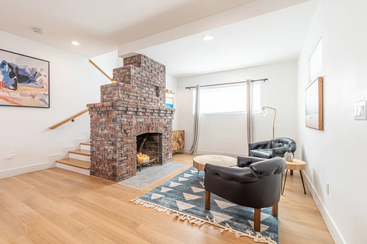 Furnished living room with original brick fireplace — Liberty St, Reno